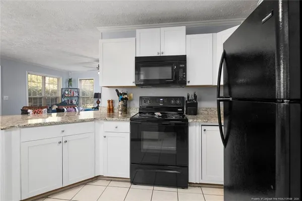 a kitchen with a refrigerator and a stove top oven