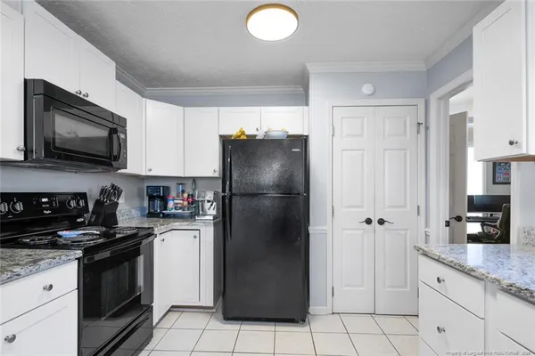 a kitchen with a refrigerator sink and microwave
