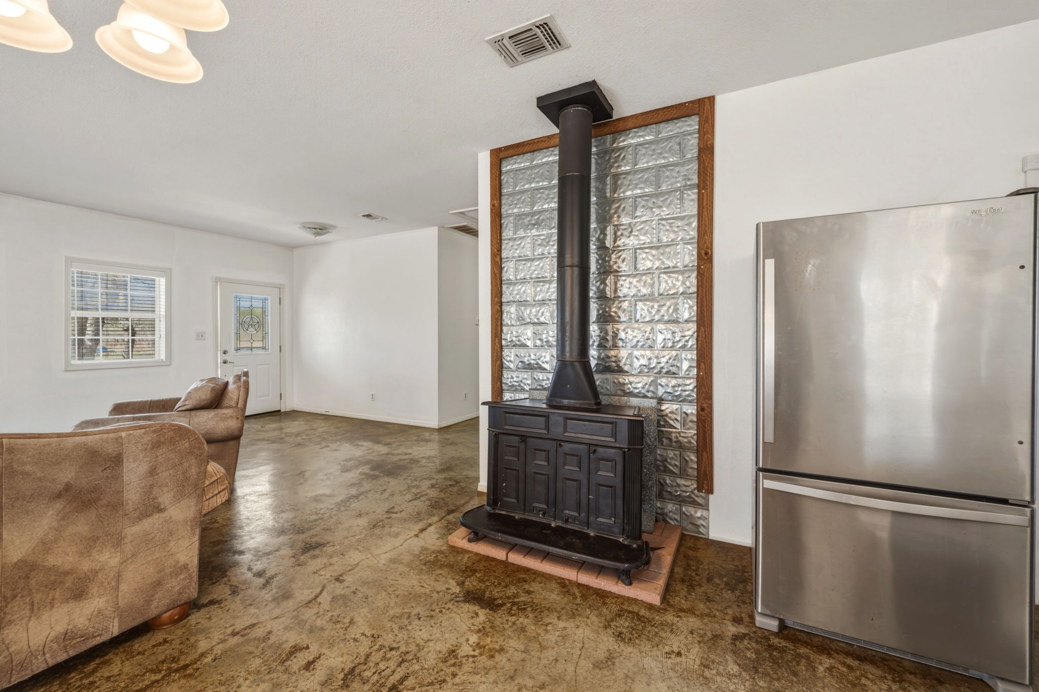1301 Altwein Road Blanco, TX 78606 - Photo 18 of 40 Living room with concrete floors and a wood stove