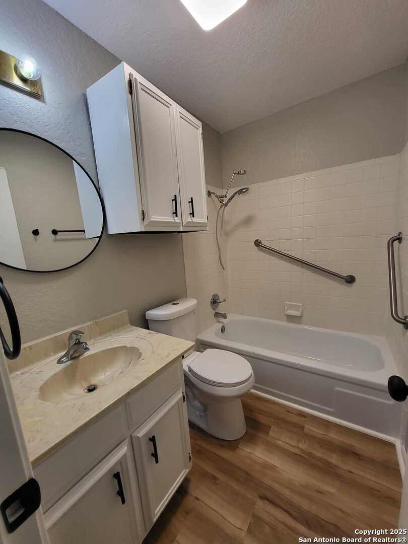 1051 Country Club Drive, Unit 19 Seguin, TX 78155 - Photo 11 of 17 a bathroom with a sink a toilet and bathtub