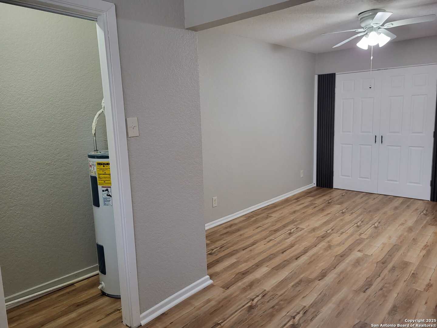 1051 Country Club Drive, Unit 19 Seguin, TX 78155 - Photo 12 of 17 a view of empty room with wooden floor