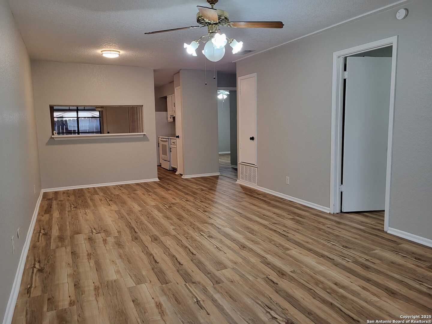 1051 Country Club Drive, Unit 19 Seguin, TX 78155 - Photo 4 of 17 a view of an empty room with wooden floor