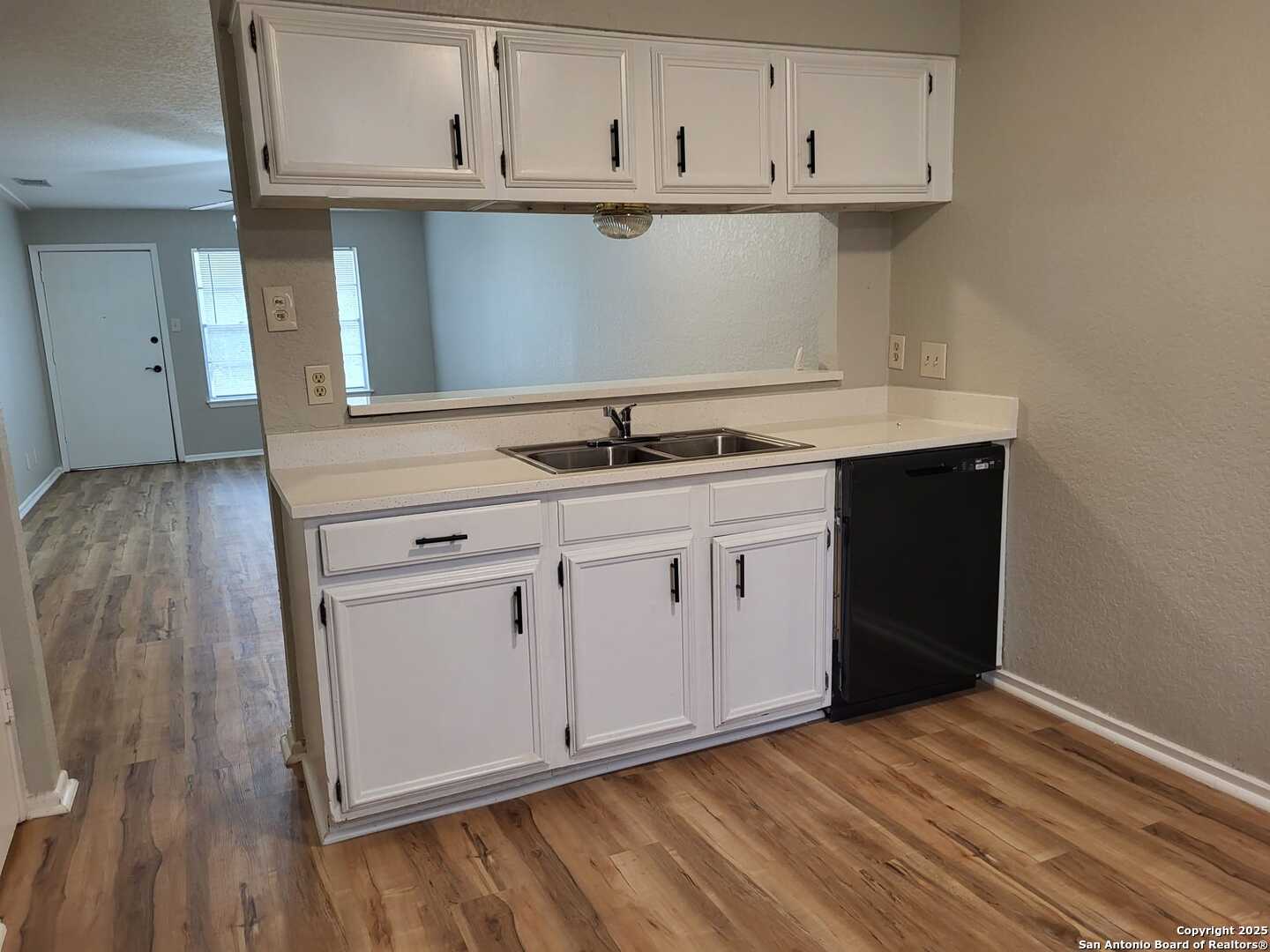 1051 Country Club Drive, Unit 19 Seguin, TX 78155 - Photo 8 of 17 a kitchen with granite countertop a sink cabinets and stainless steel appliances