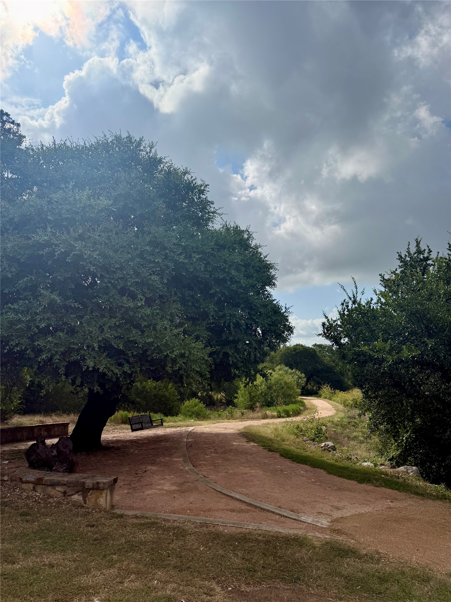 105 Merrick Road Georgetown, TX 78628 - Photo 23 of 23 A tranquil pathway meanders through verdant landscapes, offering serene outdoor moments.