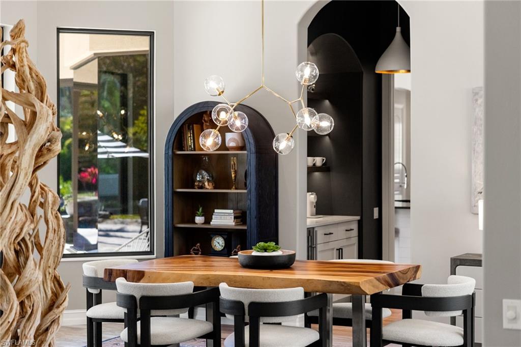6610 Sable Ridge Lane Naples, FL 34109 - Photo 16 of 47 a view of a dining room with furniture and chandelier