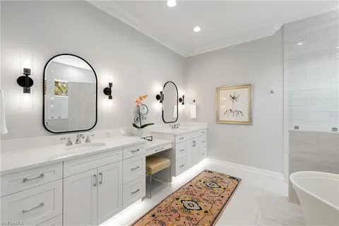 a bathroom with a double vanity sink and a mirror