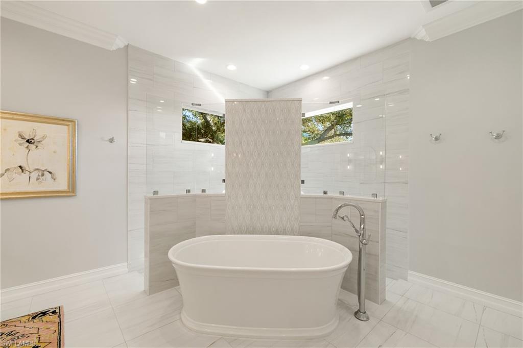 6610 Sable Ridge Lane Naples, FL 34109 - Photo 19 of 47 a white bath tub sitting next to a shower