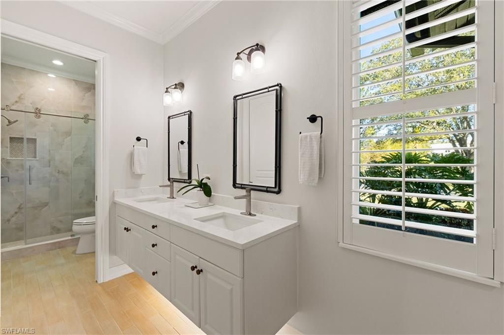 6610 Sable Ridge Lane Naples, FL 34109 - Photo 22 of 47 a bathroom with a double vanity sink mirror and shower