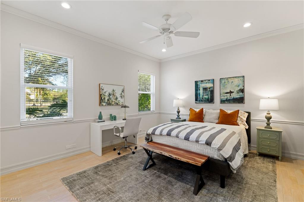 6610 Sable Ridge Lane Naples, FL 34109 - Photo 23 of 47 a bedroom with a bed and a chandelier