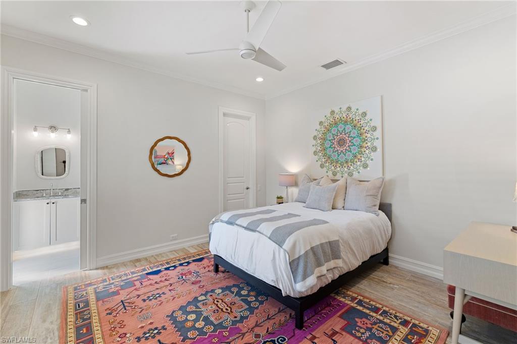 6610 Sable Ridge Lane Naples, FL 34109 - Photo 24 of 47 a bedroom with a bed and a lamp on dresser