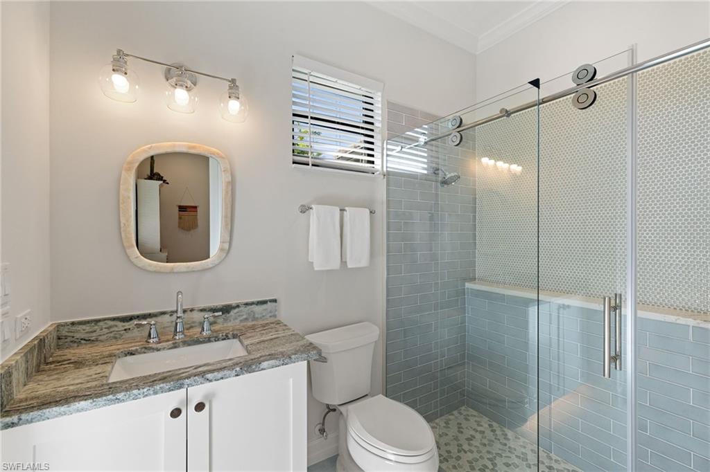 6610 Sable Ridge Lane Naples, FL 34109 - Photo 25 of 47 a bathroom with a toilet sink and shower