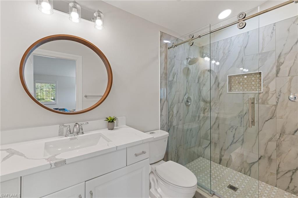 6610 Sable Ridge Lane Naples, FL 34109 - Photo 28 of 47 a bathroom with a sink a toilet and a mirror