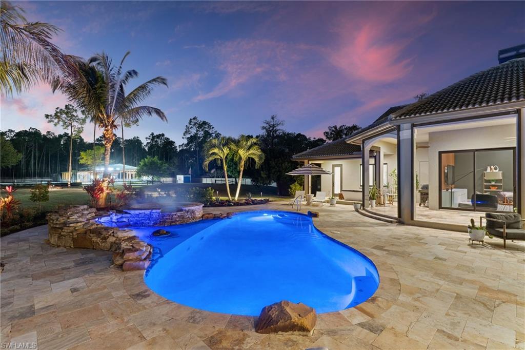 6610 Sable Ridge Lane Naples, FL 34109 - Photo 3 of 47 a view of a swimming pool with outdoor seating