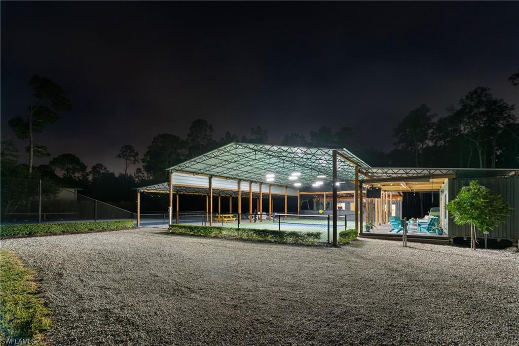 6610 Sable Ridge Lane Naples, FL 34109 - Photo 41 of 47 a view of a building with a yard and roof