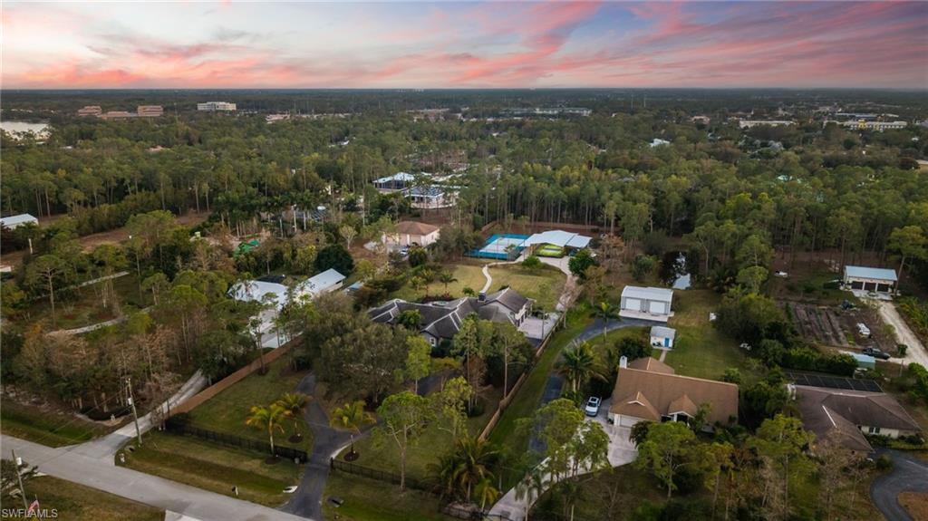 6610 Sable Ridge Lane Naples, FL 34109 - Photo 42 of 47 an aerial view of residential houses with outdoor space and trees
