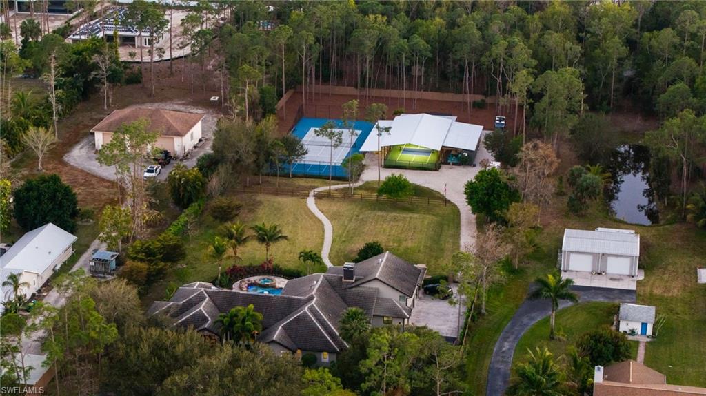 6610 Sable Ridge Lane Naples, FL 34109 - Photo 44 of 47 an aerial view of a house with a garden and lake view