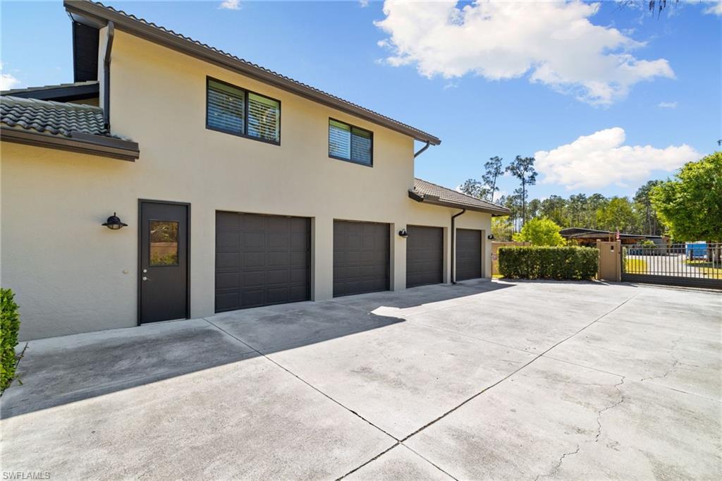 6610 Sable Ridge Lane Naples, FL 34109 - Photo 45 of 47 a front view of a house with a garage