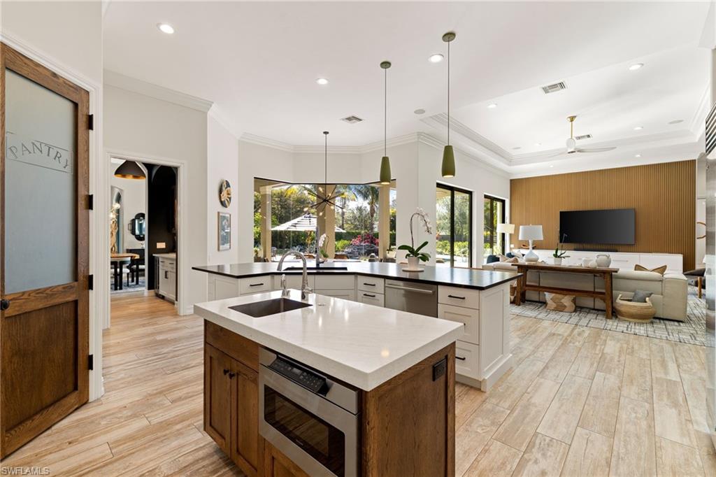 6610 Sable Ridge Lane Naples, FL 34109 - Photo 6 of 47 a kitchen with a stove and a wooden floor