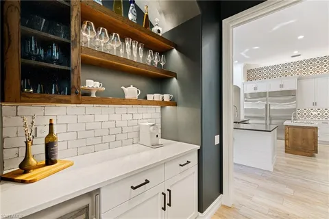 a kitchen with a refrigerator and a sink