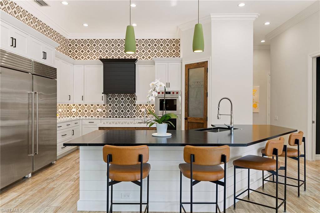 6610 Sable Ridge Lane Naples, FL 34109 - Photo 10 of 47 a living room with furniture and a chandelier