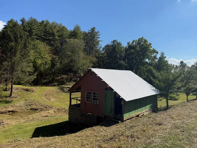 a view of a house with a yard covered with snow in the background