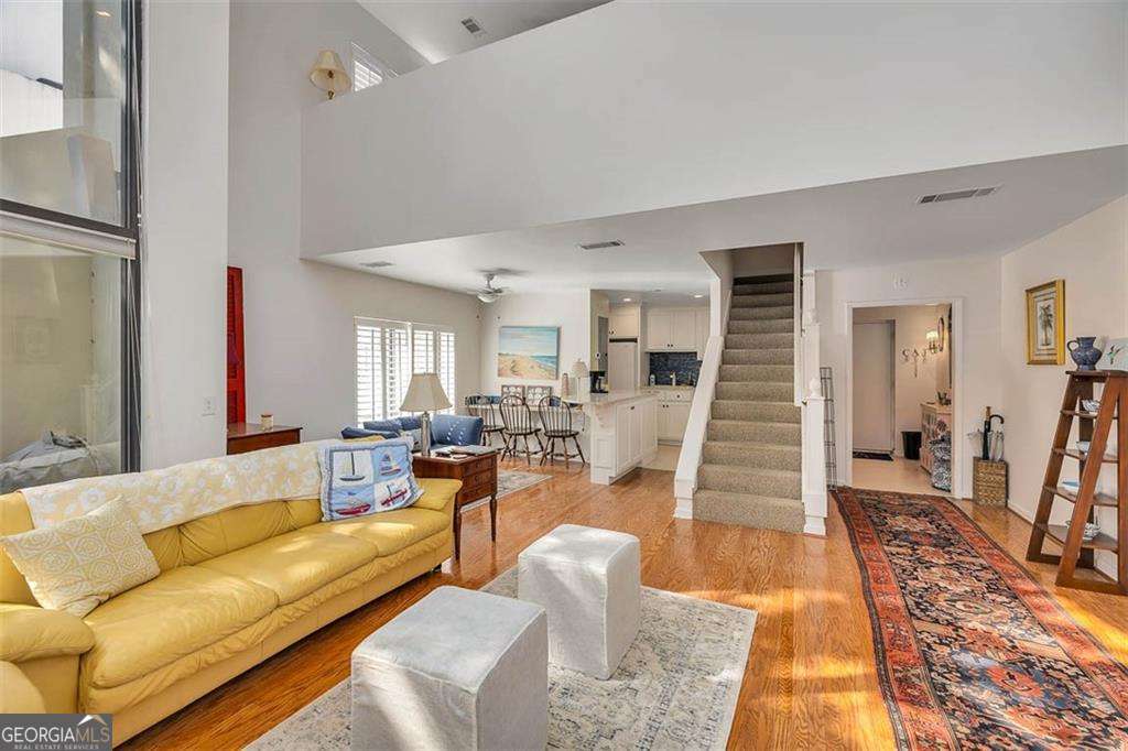 548 Oglethorpe Avenue, Unit 11 St. Simons, GA 31522 - Photo 12 of 25 a living room with furniture and a wooden floor
