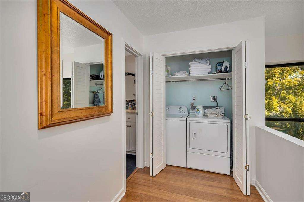 548 Oglethorpe Avenue, Unit 11 St. Simons, GA 31522 - Photo 18 of 25 a view of a hallway with wooden floor and a cabinet