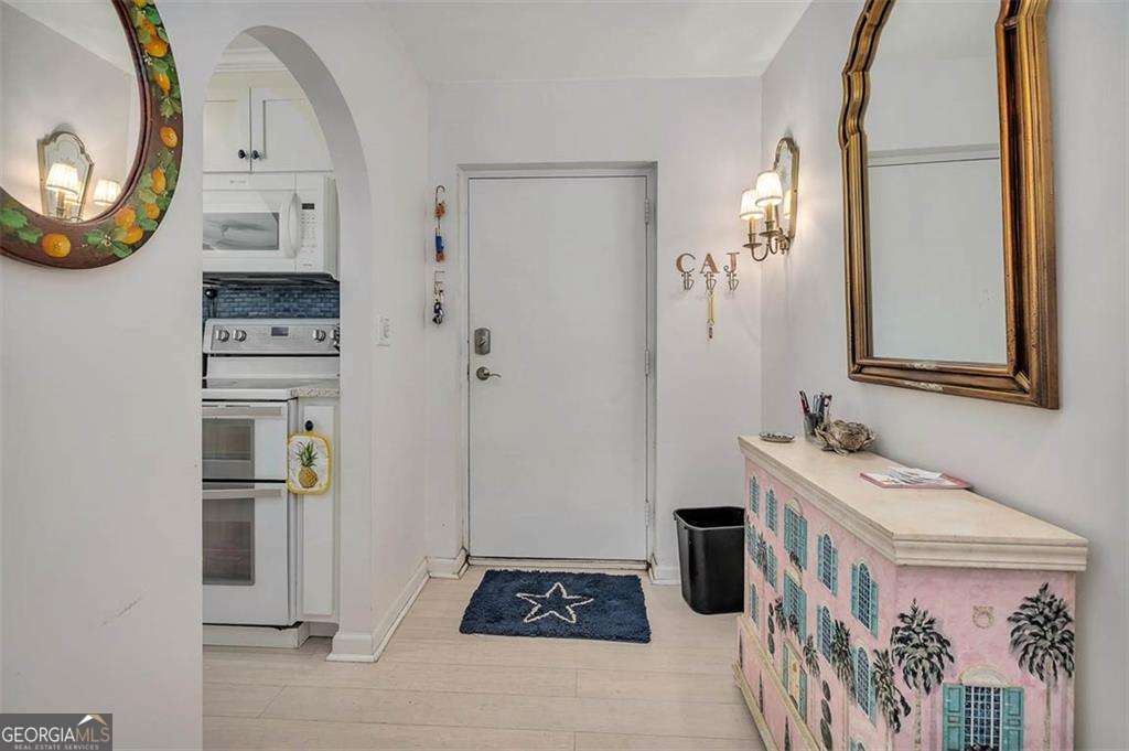 548 Oglethorpe Avenue, Unit 11 St. Simons, GA 31522 - Photo 6 of 25 a bathroom with a sink a mirror and a shower