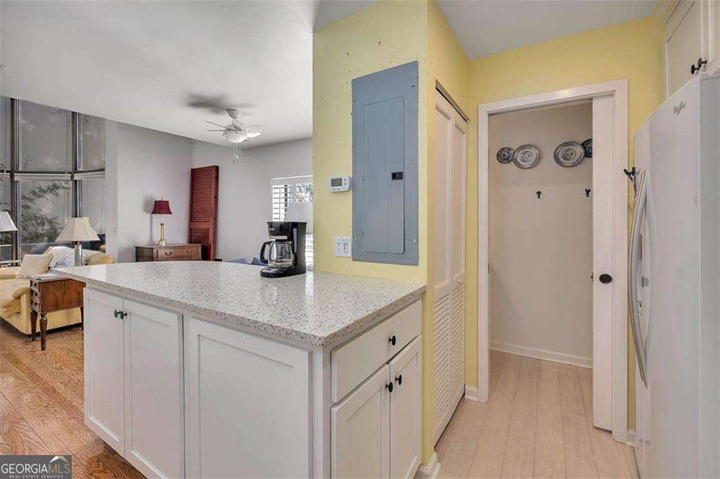 548 Oglethorpe Avenue, Unit 11 St. Simons, GA 31522 - Photo 10 of 25 a kitchen with a sink and cabinets