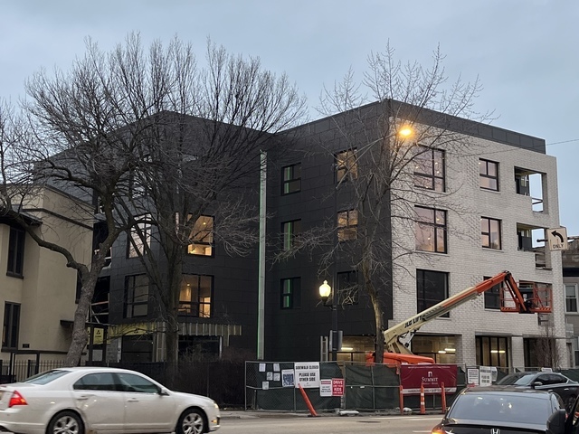 a front view of a building with parking space