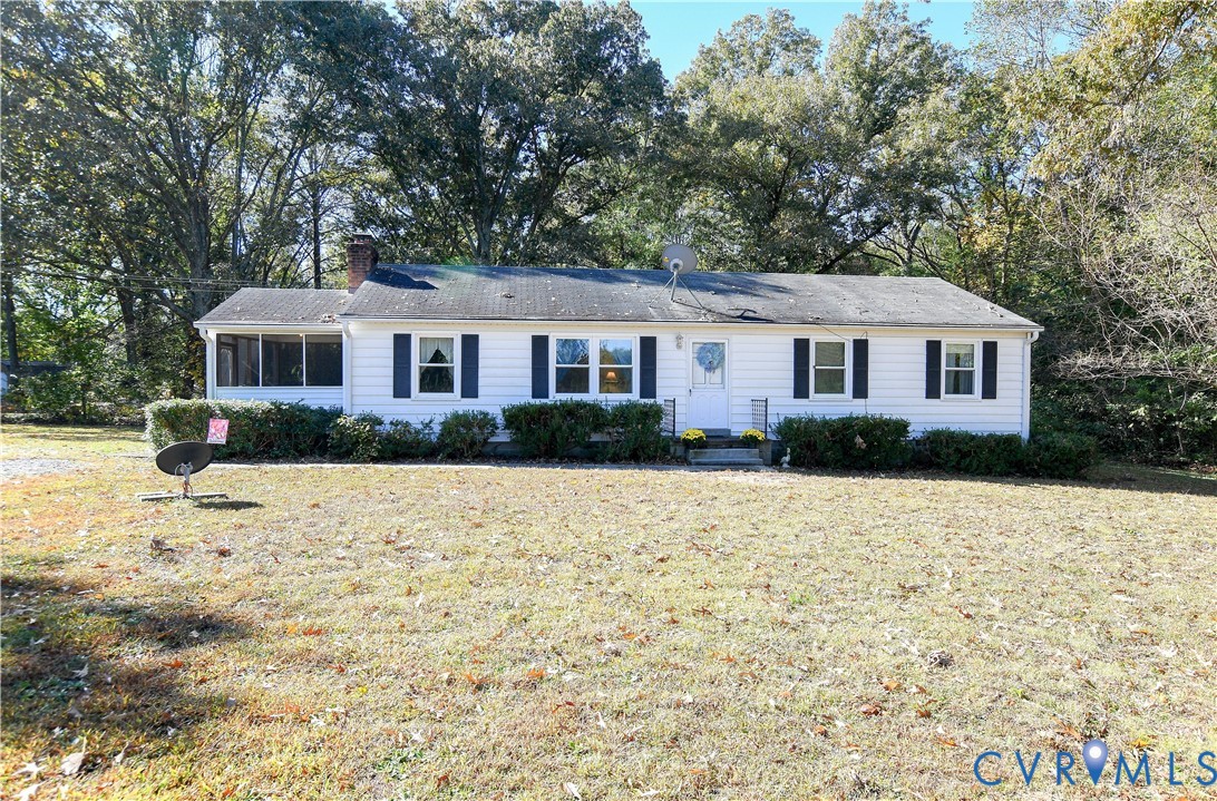 a front view of a house with a yard and trees