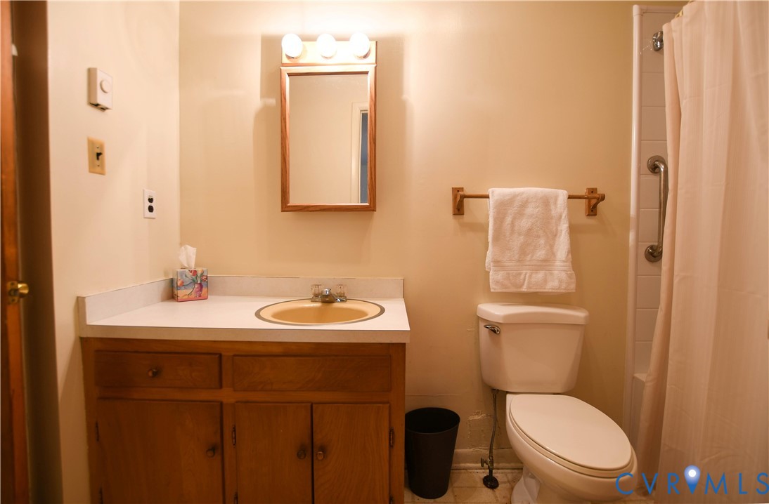 8071 Dabneys Mill Road Manquin, VA 23106 - Photo 13 of 25 a bathroom with a toilet a sink and mirror