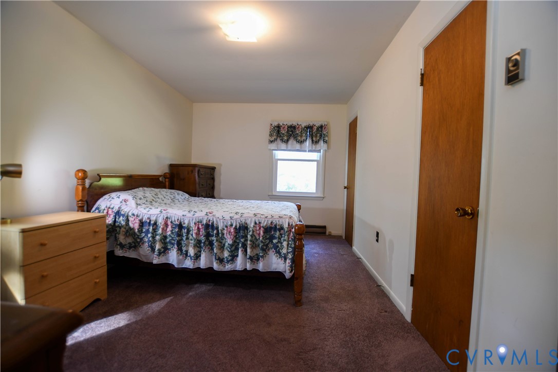 8071 Dabneys Mill Road Manquin, VA 23106 - Photo 14 of 25 a bedroom with a bed and window