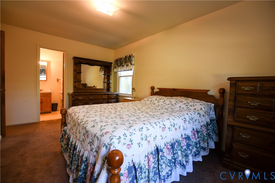 8071 Dabneys Mill Road Manquin, VA 23106 - Photo 15 of 25 a bedroom with a bed and a dresser