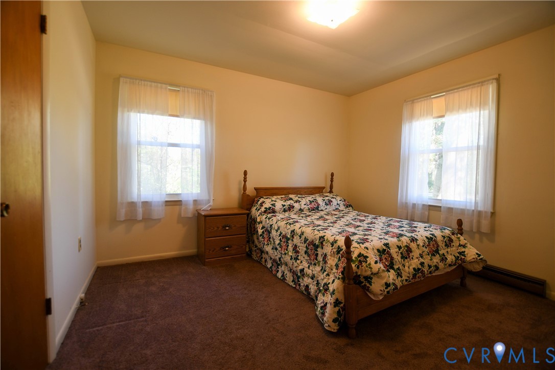 8071 Dabneys Mill Road Manquin, VA 23106 - Photo 16 of 25 a bed sitting in a bedroom next to a window