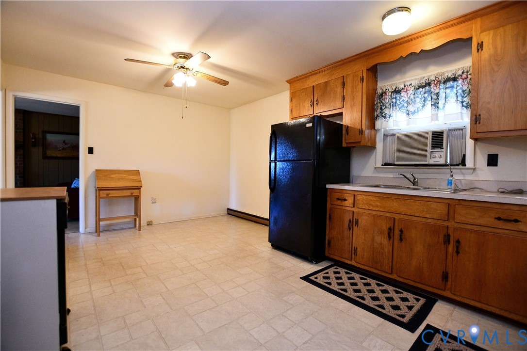 8071 Dabneys Mill Road Manquin, VA 23106 - Photo 9 of 25 a kitchen with stainless steel appliances a refrigerator and a stove top oven
