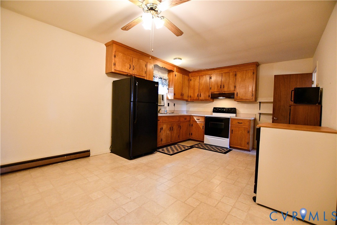 8071 Dabneys Mill Road Manquin, VA 23106 - Photo 10 of 25 a kitchen with granite countertop a refrigerator a stove a microwave and island