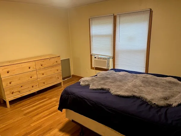 a bedroom with a bed and a dresser