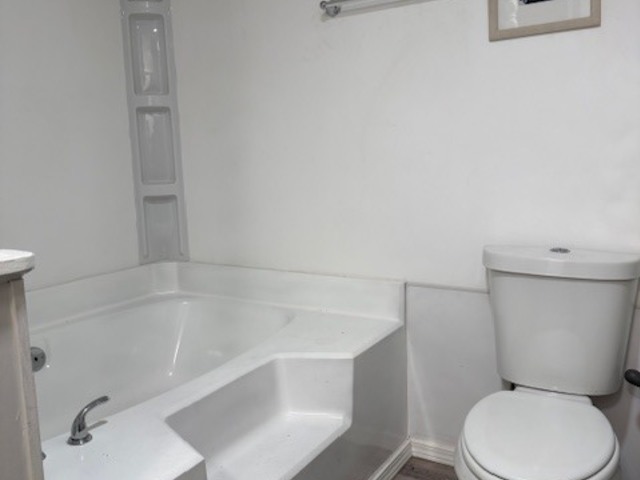 38455 North Sheridan Road, Unit 732 Beach Park, IL 60087 - Photo 20 of 25 a white toilet sitting next to a bath tub