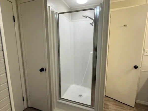 a bathroom with a glass shower door
