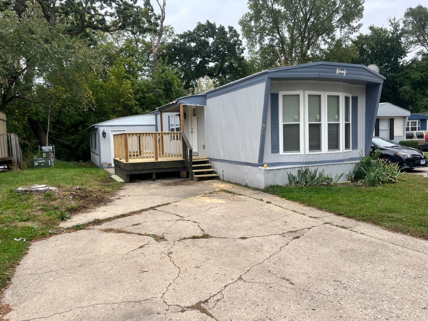 38455 North Sheridan Road, Unit 732 Beach Park, IL 60087 - Photo 3 of 25 a front view of a house with a yard and trees