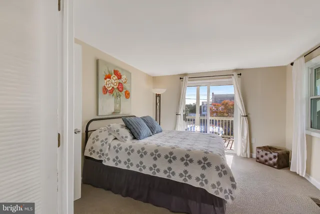 a bedroom with a bed a table and chair