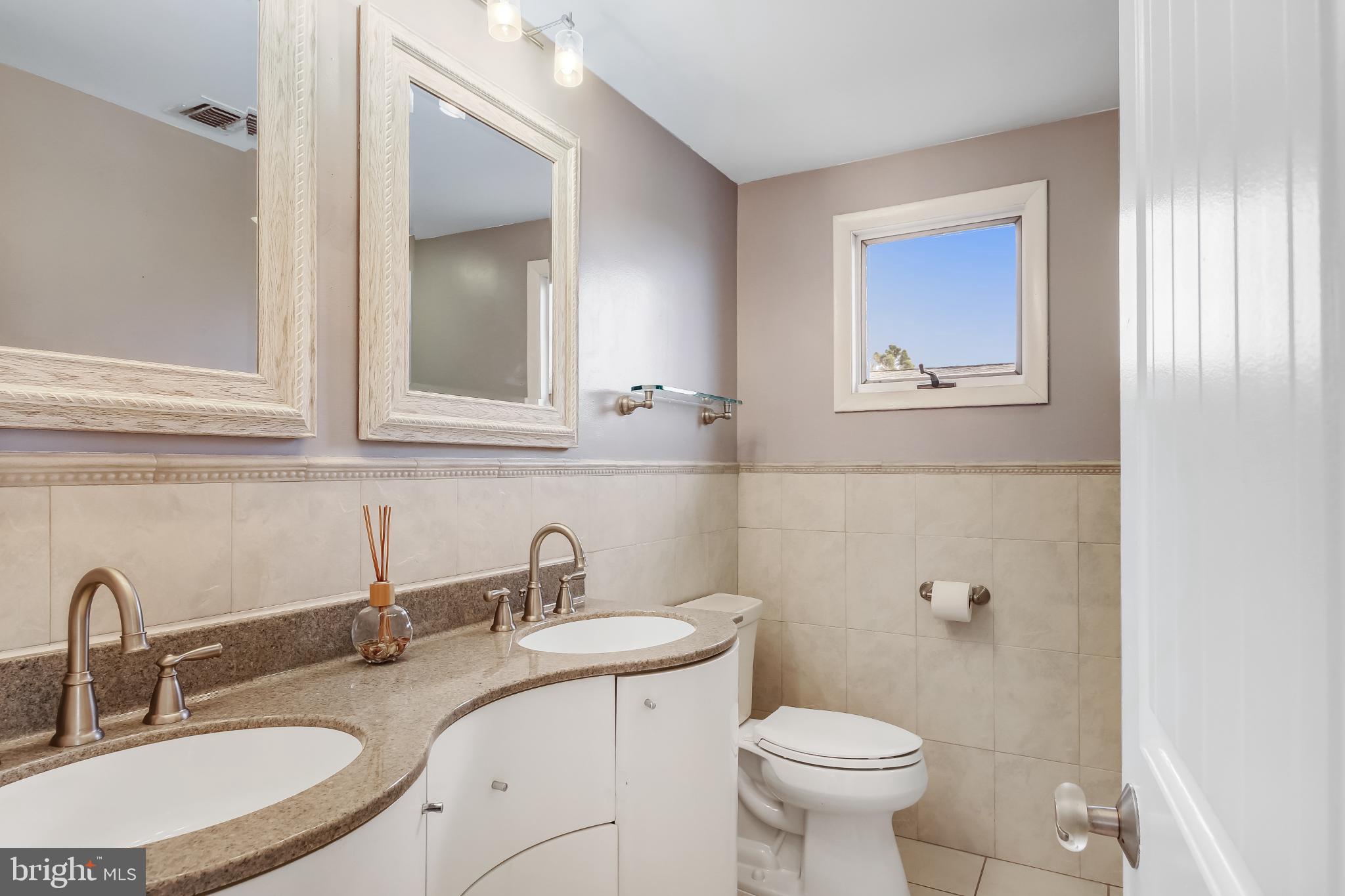 4 East 20th Street Barnegat Light, NJ 08006 - Photo 21 of 43 Elegant dual-sink bathroom with natural light.