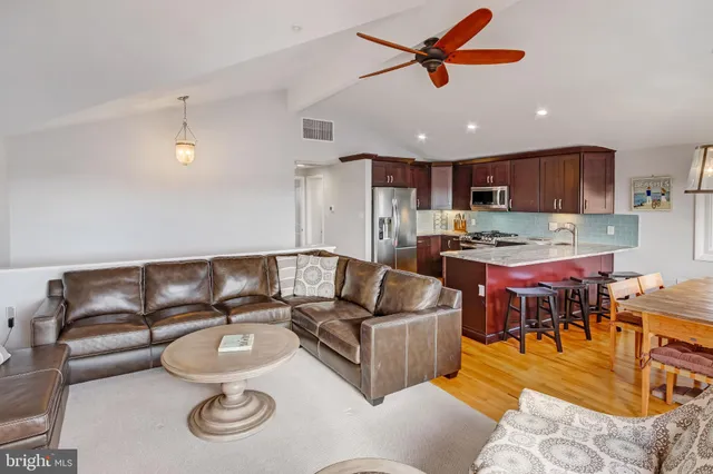 a kitchen with stainless steel appliances granite countertop a refrigerator sink and cabinets