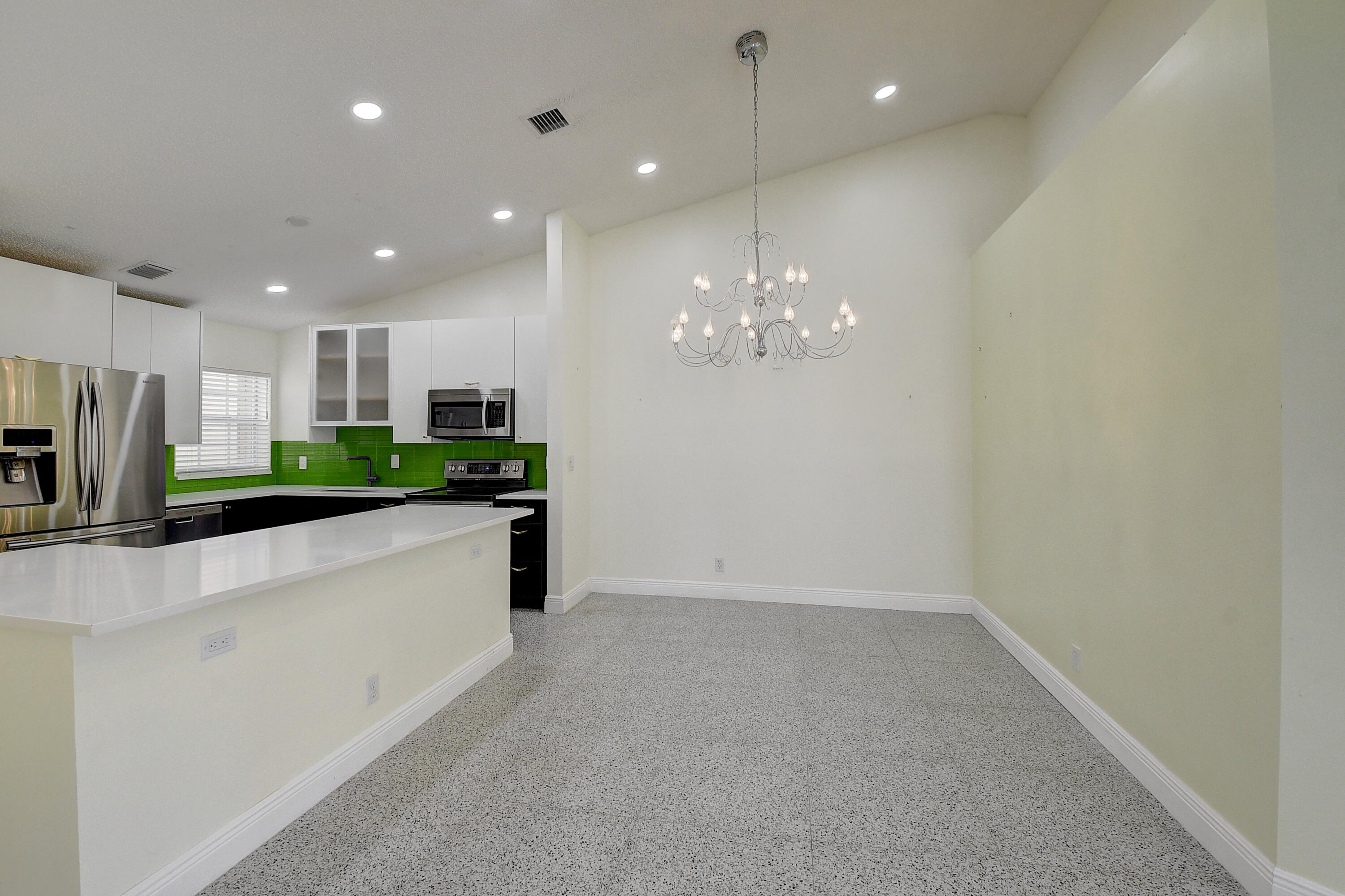 6210 Caladium Road Delray Beach, FL 33484 - Photo 11 of 59 a large kitchen with a sink and stainless steel appliances