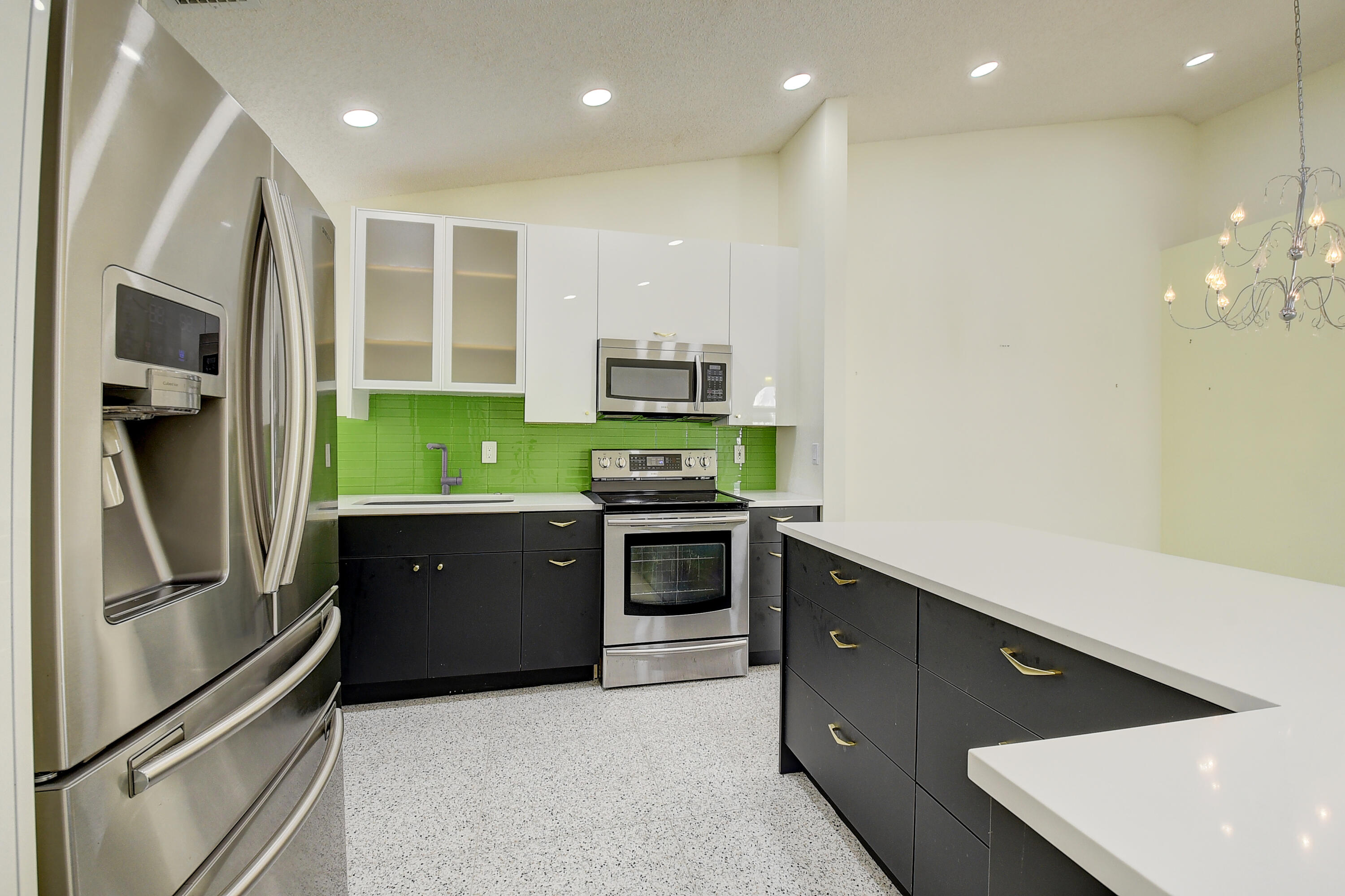 6210 Caladium Road Delray Beach, FL 33484 - Photo 14 of 59 a kitchen with stainless steel appliances granite countertop a refrigerator and a stove