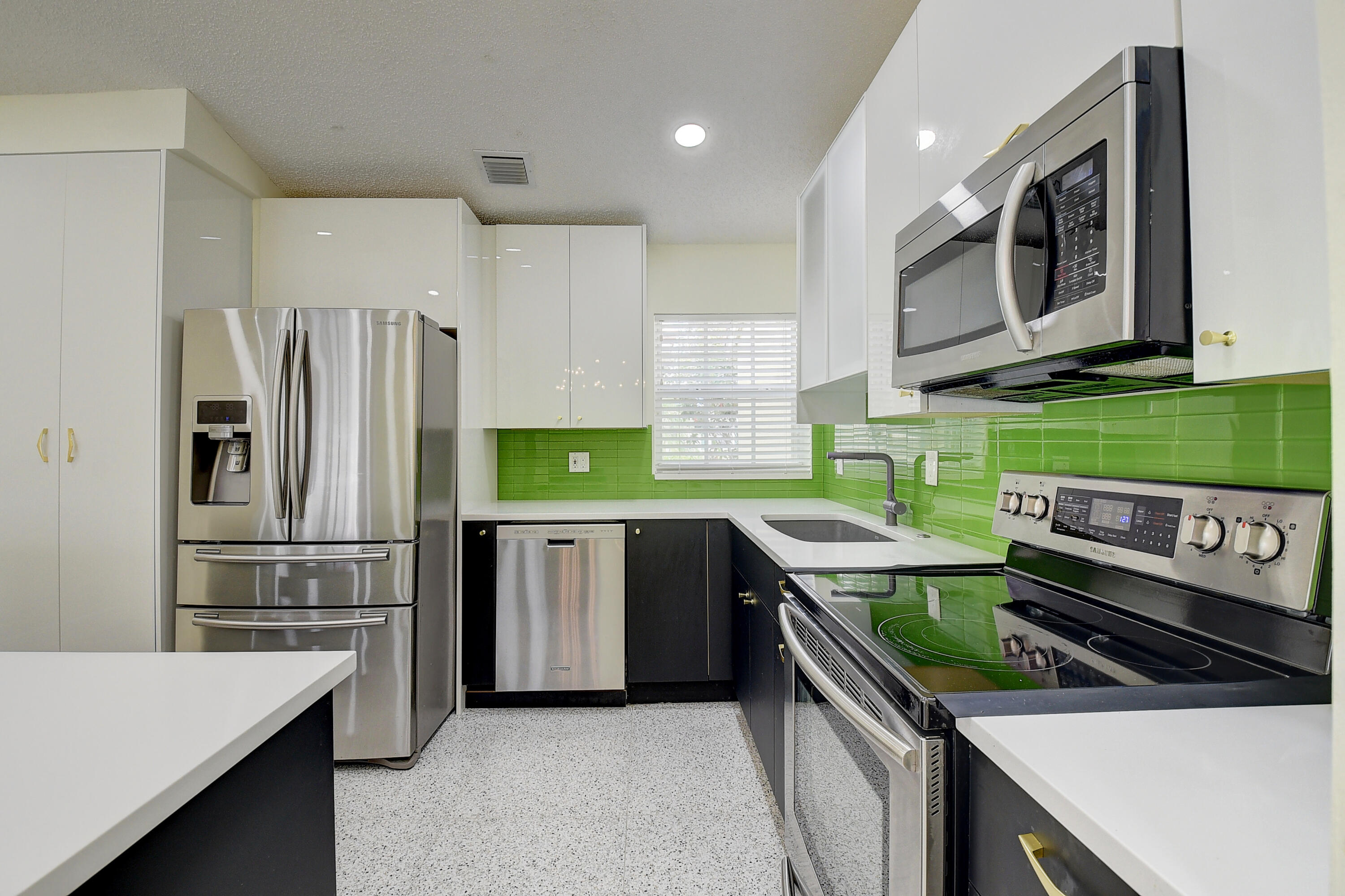 6210 Caladium Road Delray Beach, FL 33484 - Photo 15 of 59 a kitchen with a sink stove and refrigerator