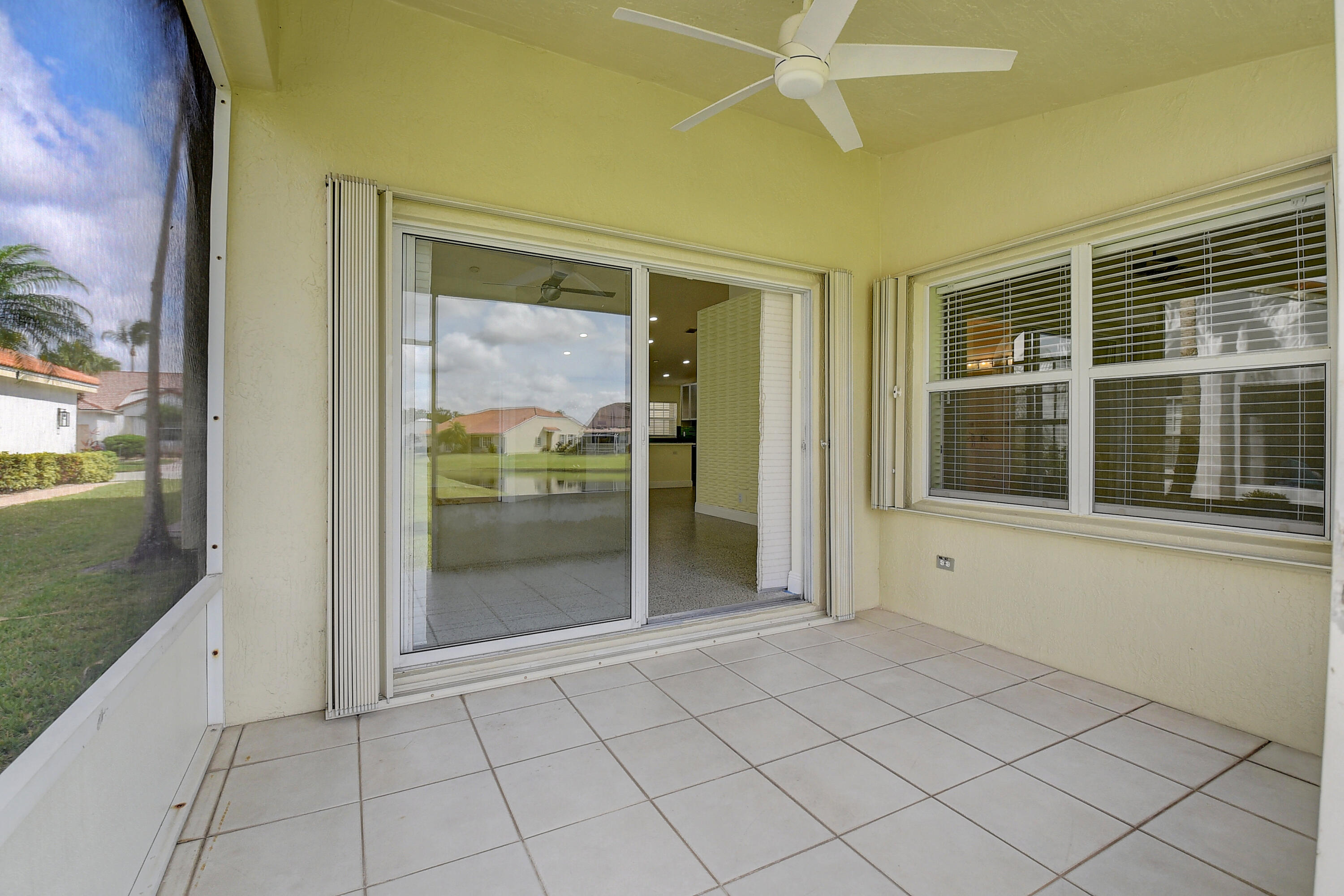 6210 Caladium Road Delray Beach, FL 33484 - Photo 28 of 59 a view of an entryway with a floor to ceiling window and wooden floor