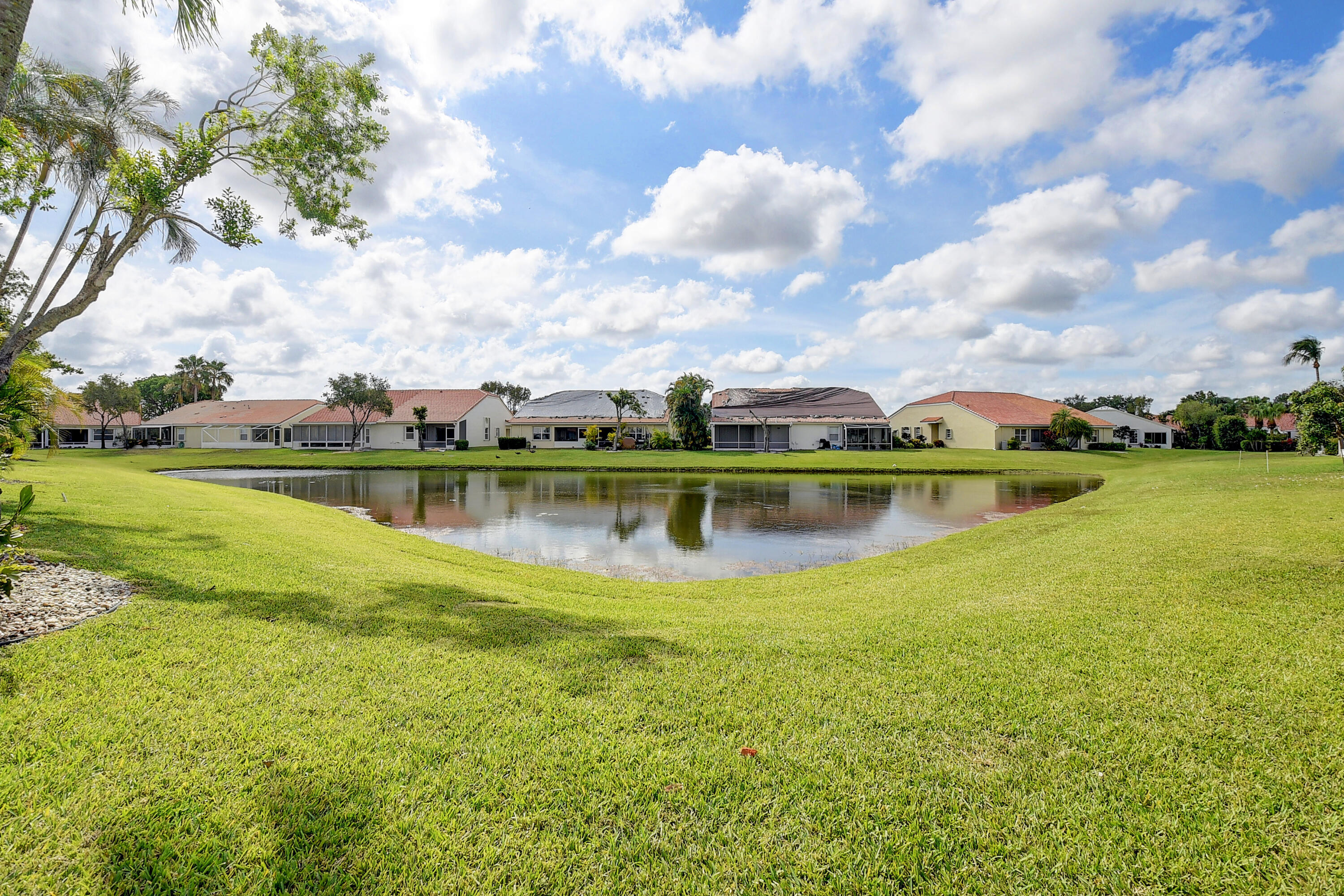 6210 Caladium Road Delray Beach, FL 33484 - Photo 29 of 59 a view of a lake with houses in the back