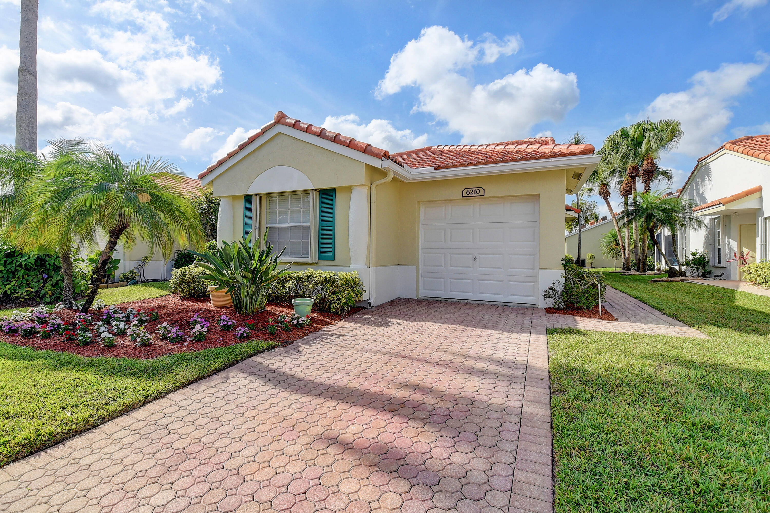 6210 Caladium Road Delray Beach, FL 33484 - Photo 3 of 59 a view of a house with a yard and potted plants